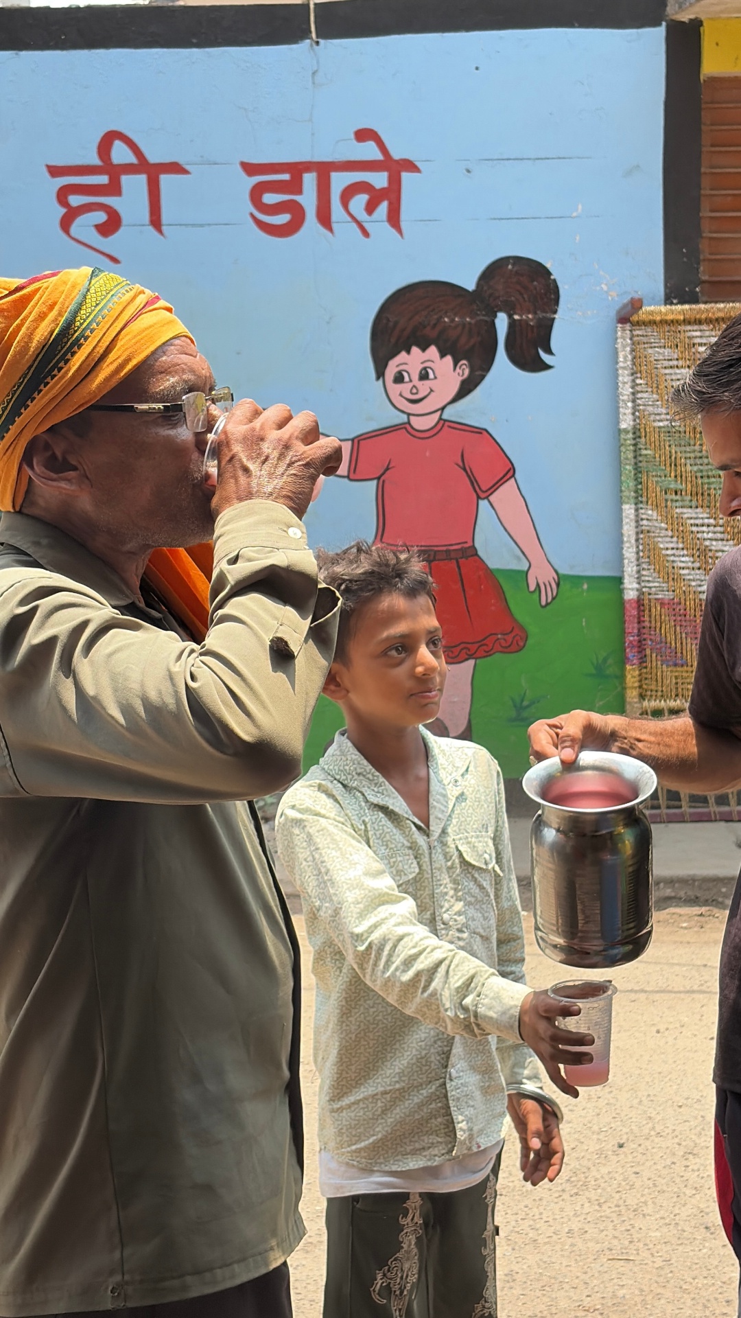Elder devotee drinking chilled Rooh Afza sharbat on Nirjala Ekadashi in Jagriti Vihar, Ghaziabad